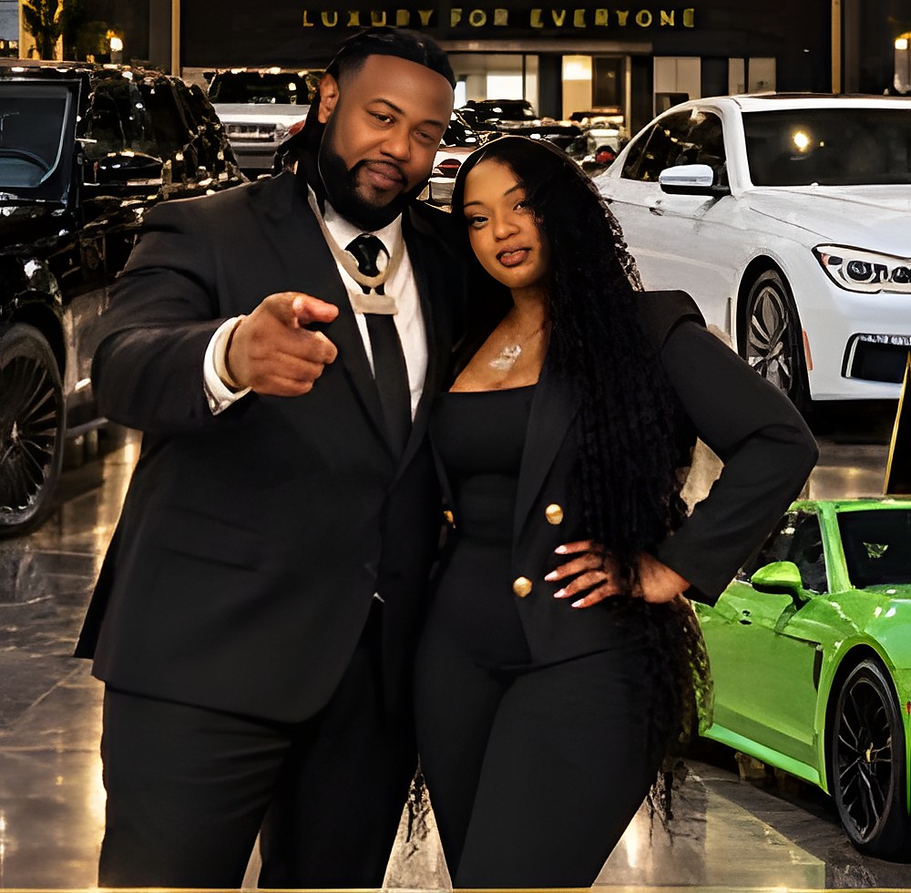 The owners of Cash Car Kings standing on the lot